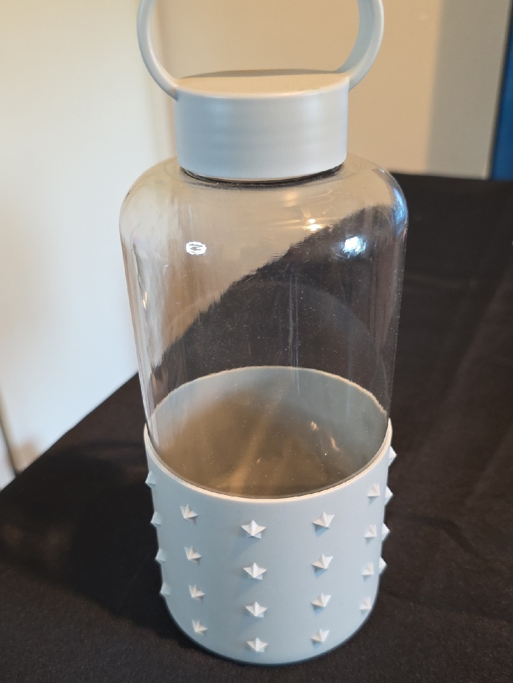 Clear Water Bottle with Light Gray Star-Studded Sleeve